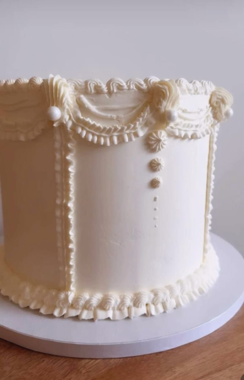 Cream vintage cake with piped swags and pearls